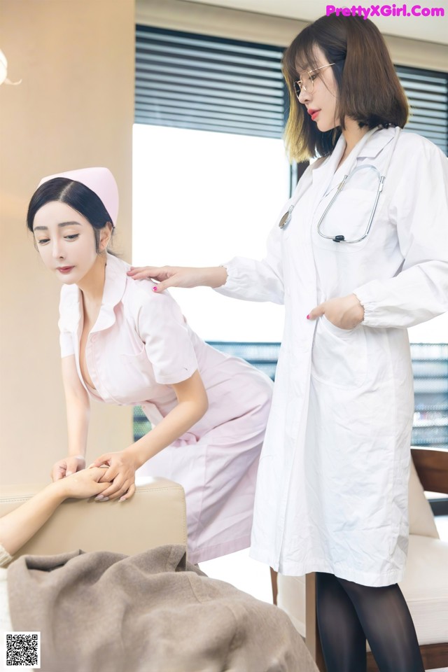 A woman in a white lab coat and a nurse in a pink dress.