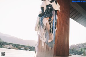 A woman sitting on top of a wooden table.