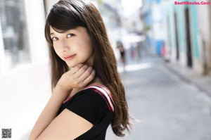 A woman in a white dress posing for a picture.