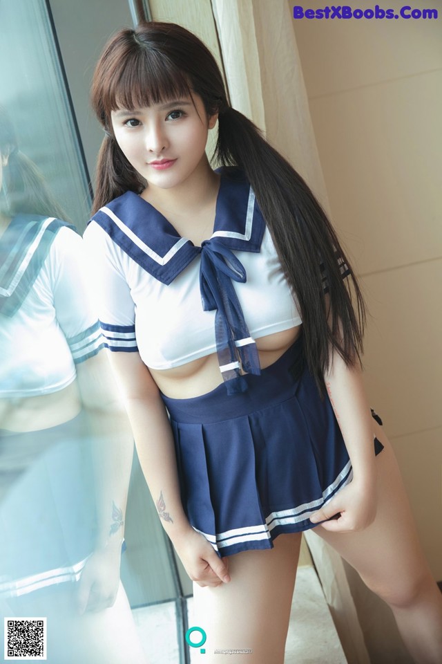 A woman in a sailor outfit posing for a picture.