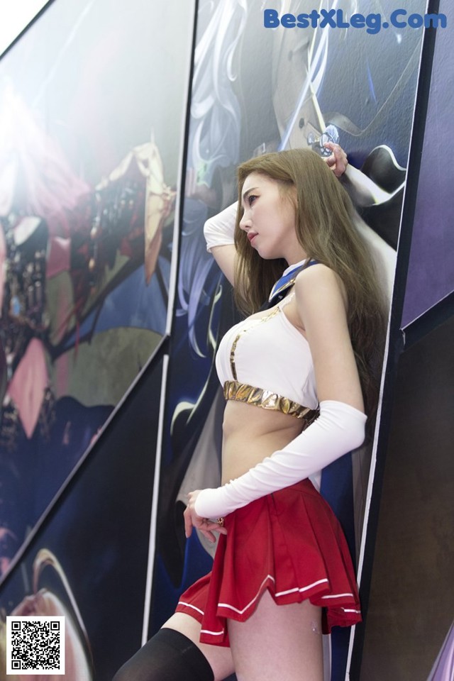 A woman in a red and white outfit posing for a picture.
