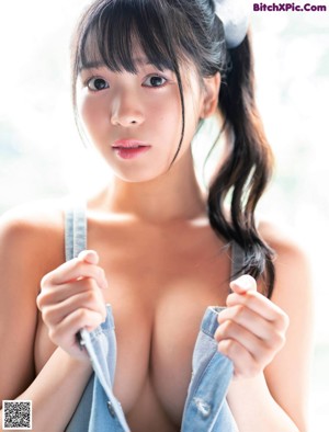 A woman in a black bra and panties posing for a magazine.