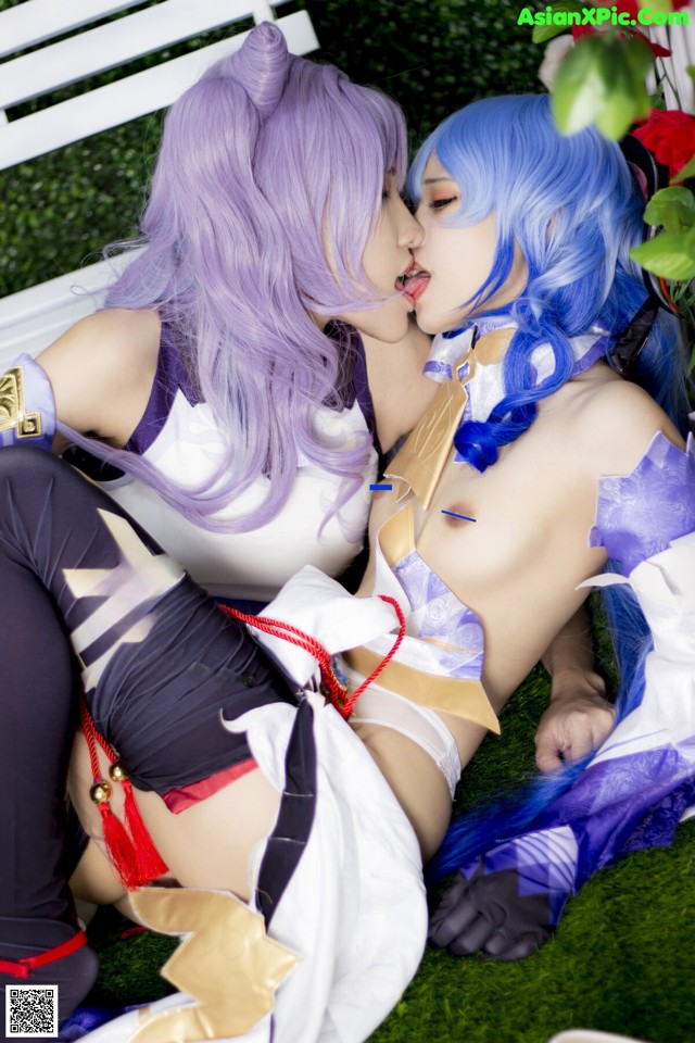 A couple of women laying on top of a white bench.
