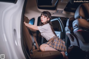 A woman sitting in the driver's seat of a car.