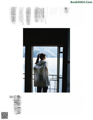 A woman sitting on a chair in front of a window.