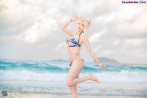 A woman in a bikini standing on the beach.