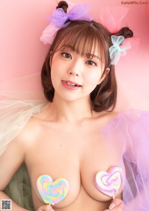A woman wearing a white bra and a black bow tie.