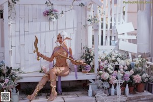 A woman in a costume sitting on a bench.