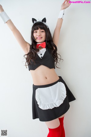 A woman in a black dress and red tights posing for a picture.