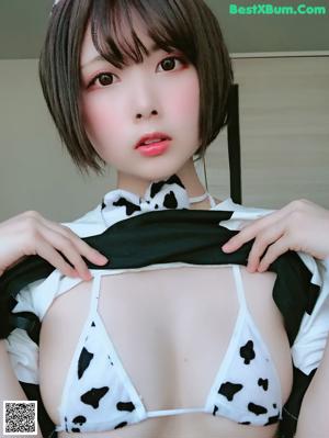 A woman in a cow costume is posing for the camera.