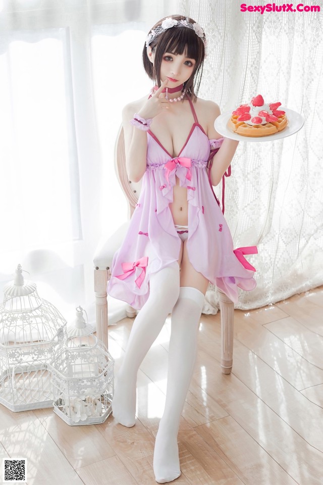 A woman in a pink lingerie holding a plate of food.